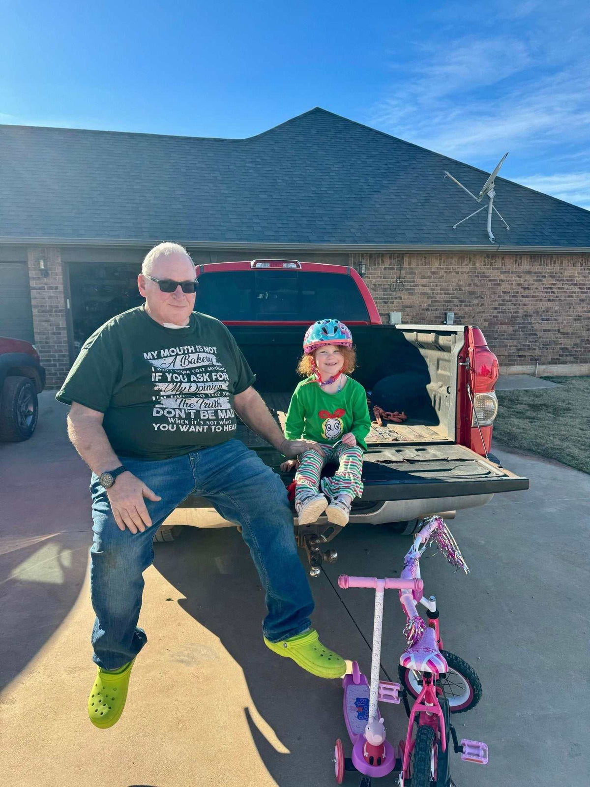 Don Channel of Blowin' Smoke Cookers sitting on a pickup truck tailgate