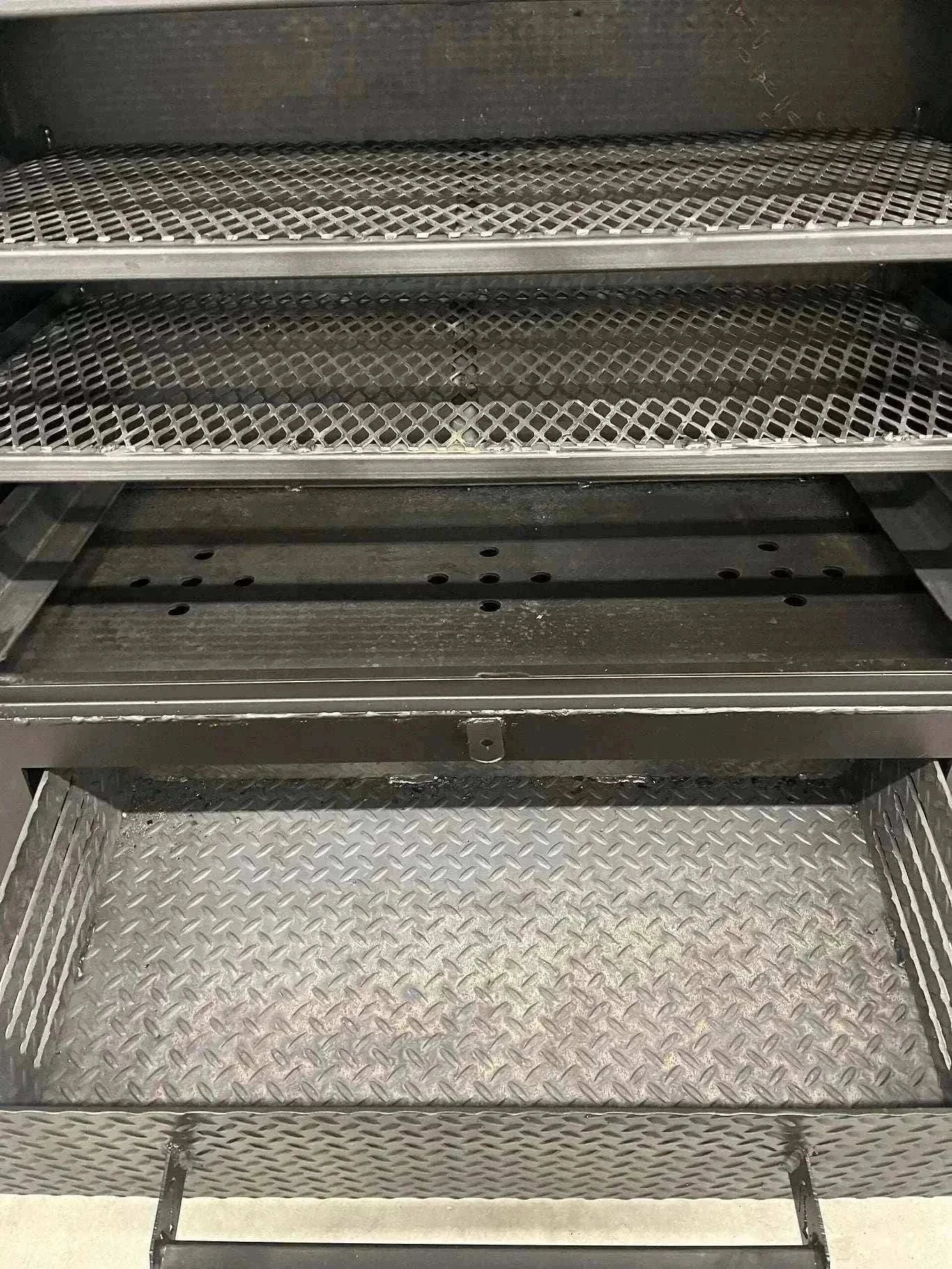Interior view of 42 Cabinet Combo Smoker showing heavy-duty steel racks and ash pan tray
