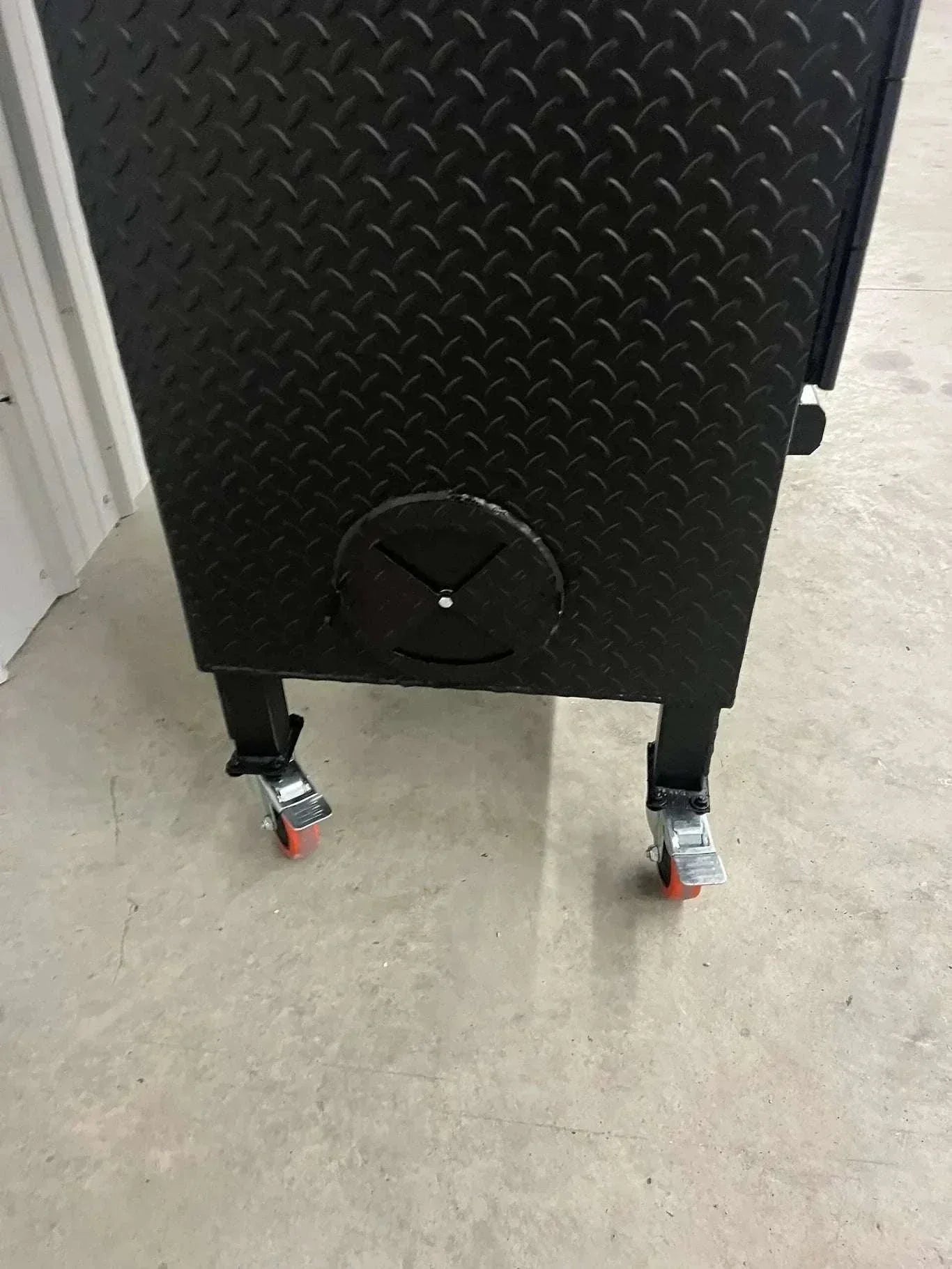 42 Cabinet Combo Smoker with compact steel construction and locking caster wheels on concrete floor