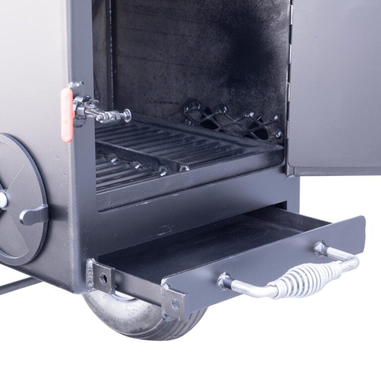 Close-up of a metal appliance with an open drawer and visible components.