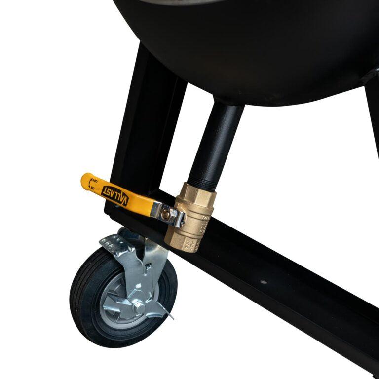 Close-up of a black barbecue grill with a yellow valve and wheel on a white background