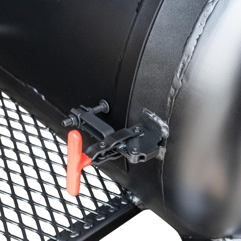 Close-up of a black metal latch with an orange handle attached to a bbq grille.