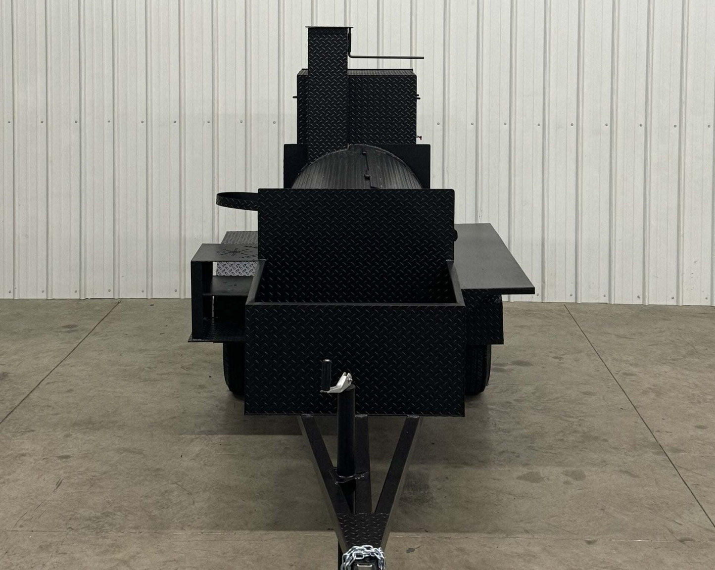 Competition 60 Barbeque Smoker with 1/4 inch rolled tread steel tank, slide out cooking racks, rib box, insulated firebox, storage basket, and rear-mounted fryer stand.