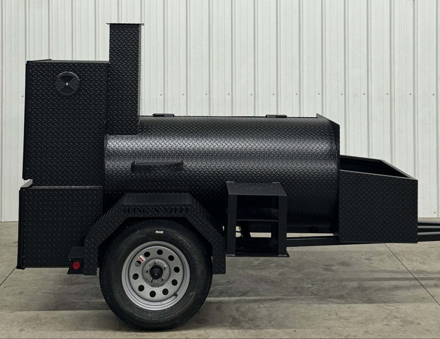Competition 60 barbeque smoker with 1/4 inch rolled tread steel, 60"x30" main tank, insulated firebox, rib box, storage basket, and mounted fryer stand.