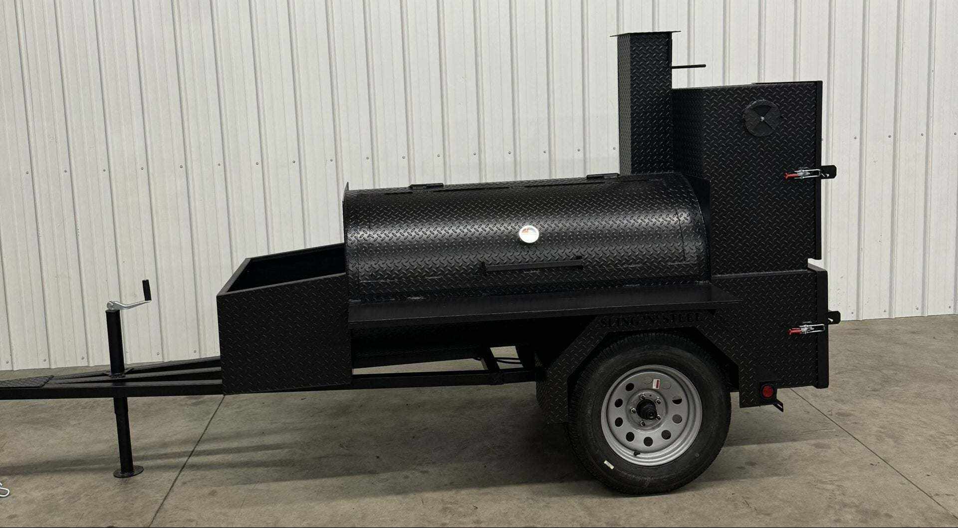 Competition 60 Smoker trailer-mounted barbeque smoker with large cooking racks, rib box, insulated firebox, and storage basket in black steel