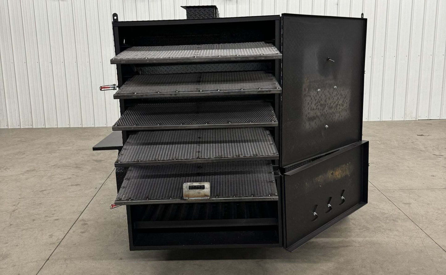 Custom charcoal grill and SNS 4060 smoker with multiple cooking racks for versatile catering use.