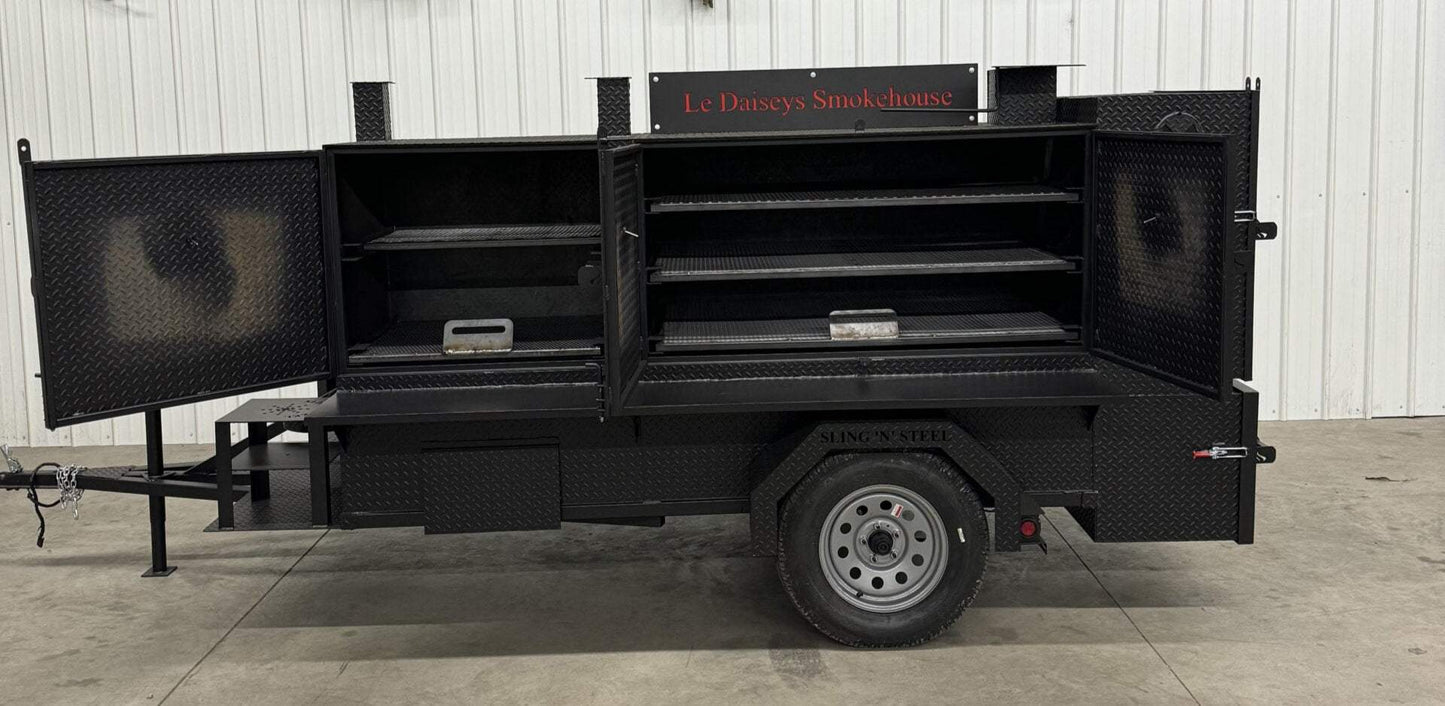 Custom charcoal grills and SNS 4060 smoker trailer with open doors for catering and smoking food