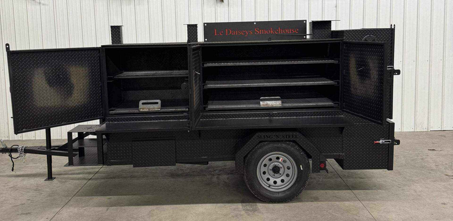 Custom charcoal grills with SNS 4060 smoker on a trailer for versatile catering and smoking needs