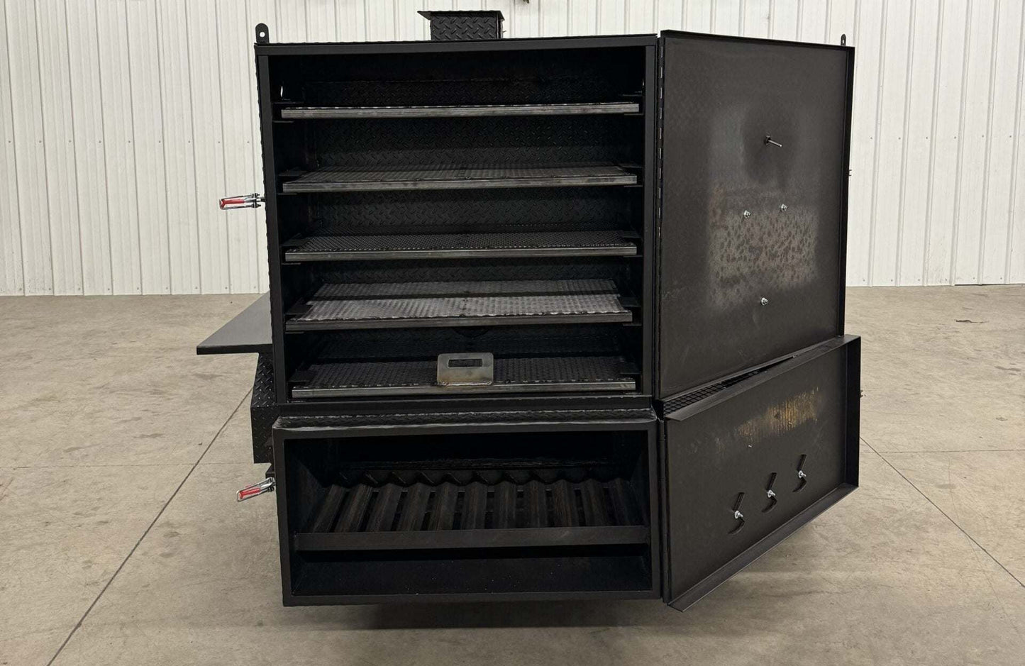 Custom charcoal grill with SNS 4060 smoker showcasing multiple cooking racks and firebox door open for catering use.