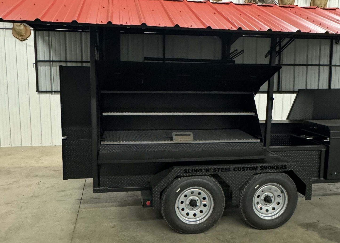 Custom Ultimate Smokehouse 72-inch smoker on trailer with roof, sink package, and multiple pull-out cooking racks