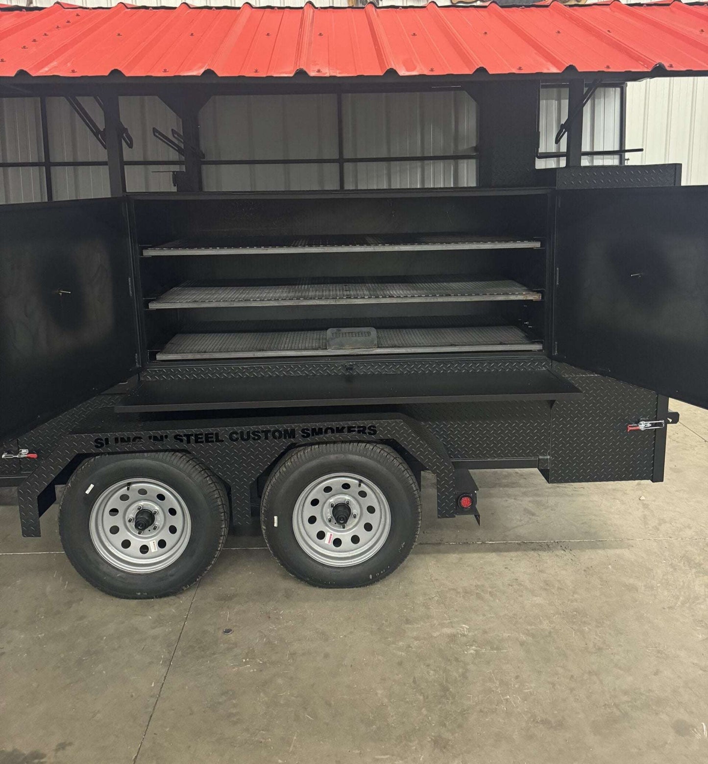 72-inch custom smoker on trailer with triple slide-out cooking racks and insulated firebox for large-scale BBQ cooking