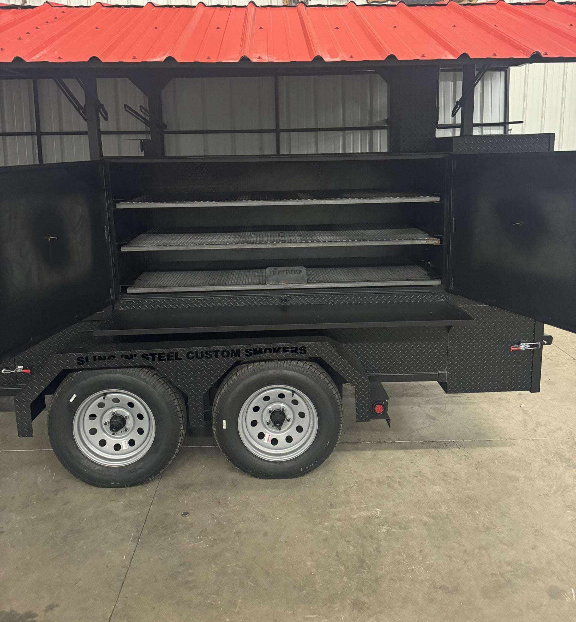 72-inch custom smoker on trailer with three large pull-out cooking racks and double-walled insulated firebox under red roof