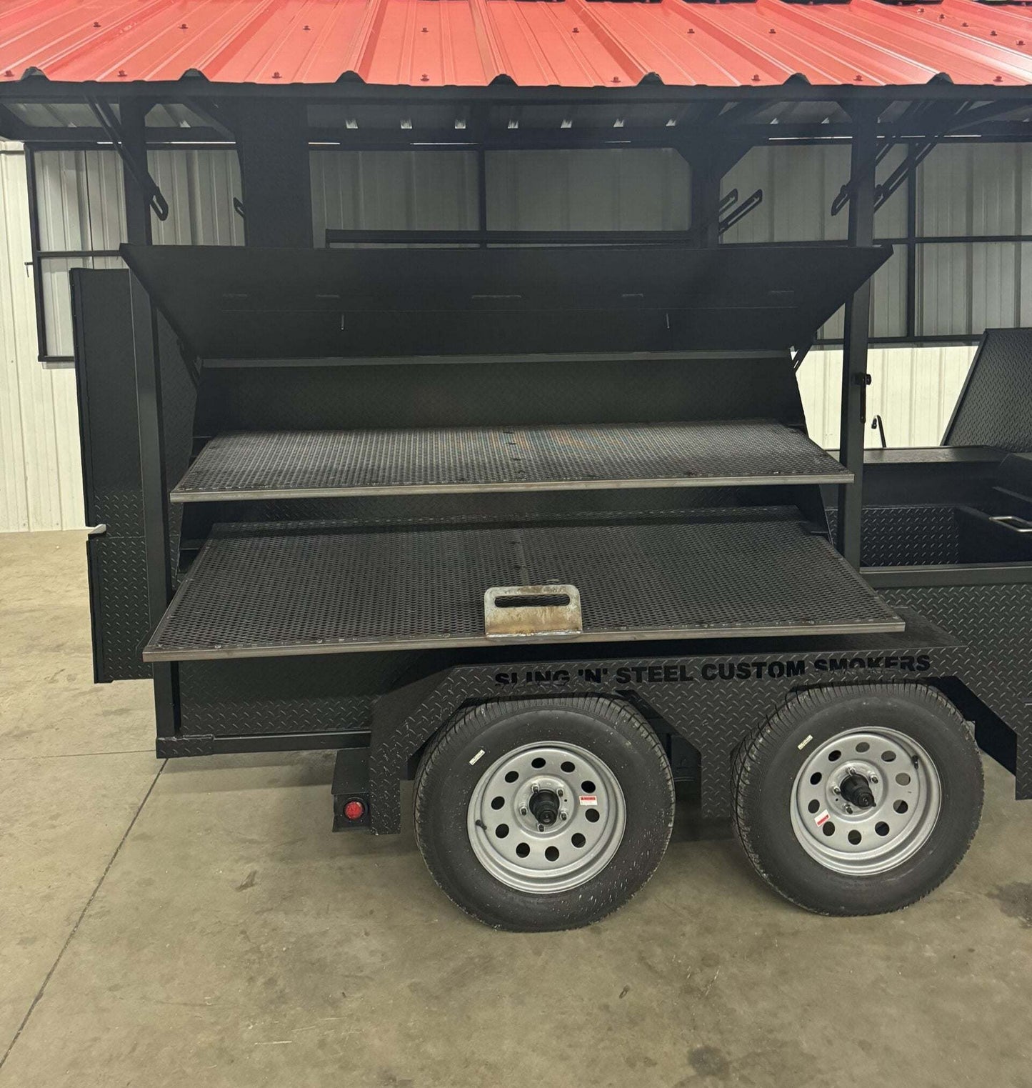 Custom Ultimate Smokehouse 72-inch smoker on trailer with dual cooking racks and diamond tread steel cabinet
