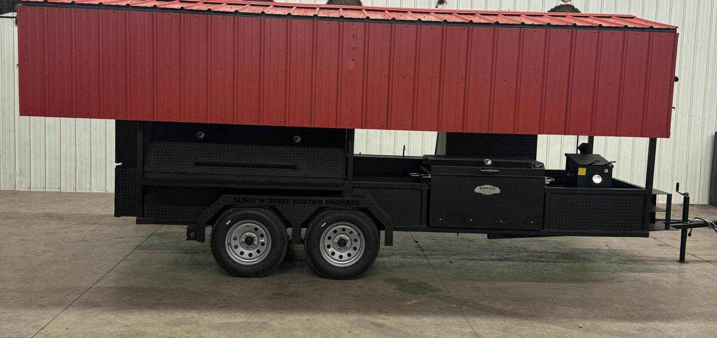 Large custom smoker on trailer with red roof, multiple cooking racks, insulated firebox, sink, and griddle for high-capacity barbecue cooking