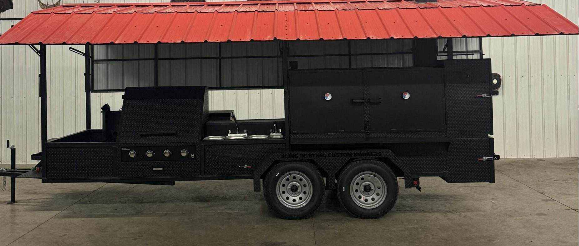 Smoker on trailer Ultimate Smokehouse 72 with chicken flipper, sink, griddle, and XL charcoal grill on dual-axle trailer