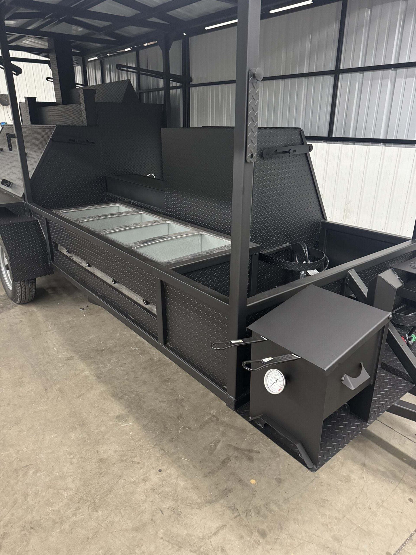 Commercial Smoker Custom Ultimate Smokehouse 72 with griddle, large charcoal smoker, multiple cooking racks, sink package, and warming box in a commercial setup