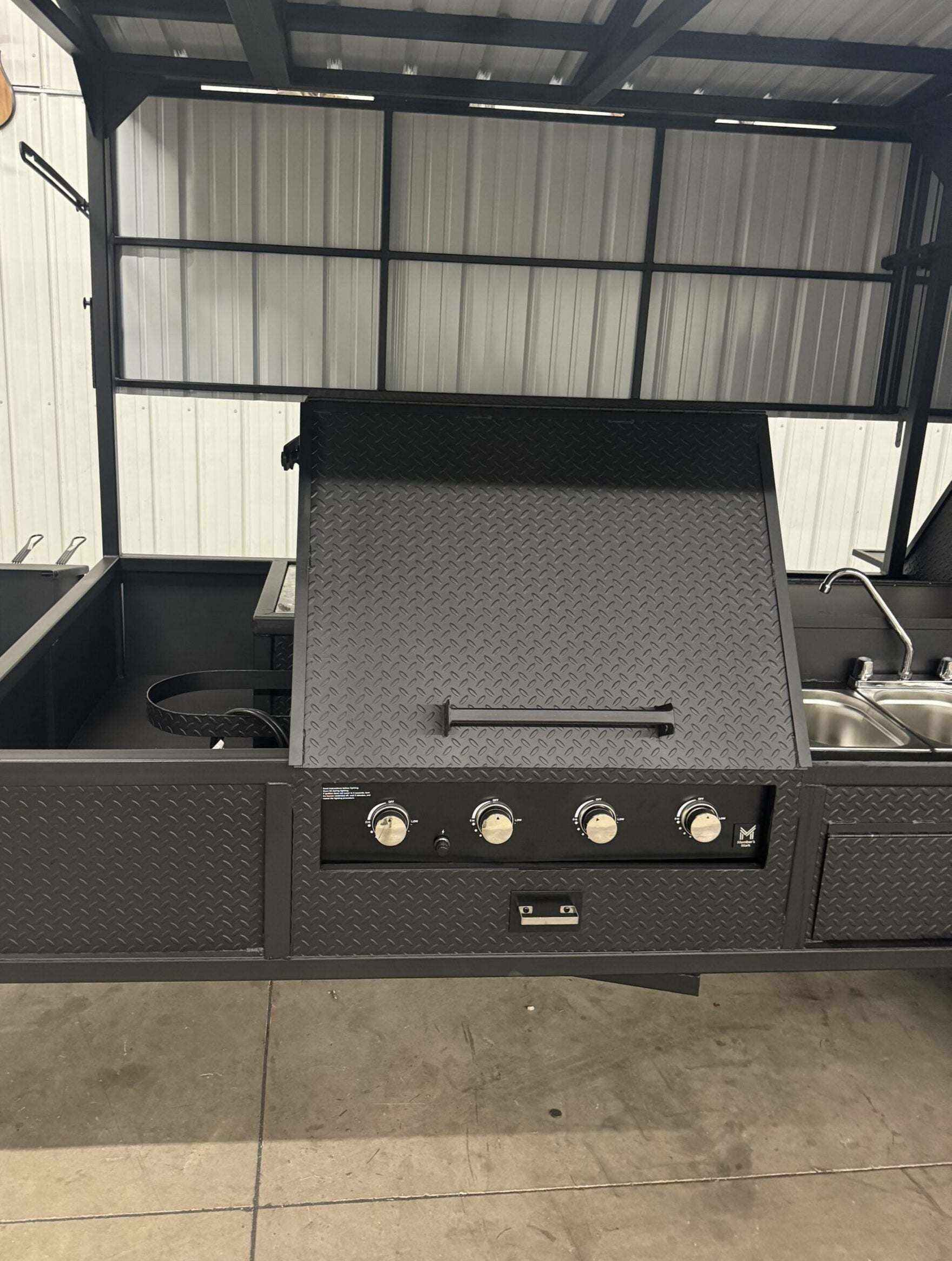 Custom Ultimate Smokehouse 72 commercial smoker with 36-inch griddle, four-bay sink package, and large charcoal grill in diamond tread steel design