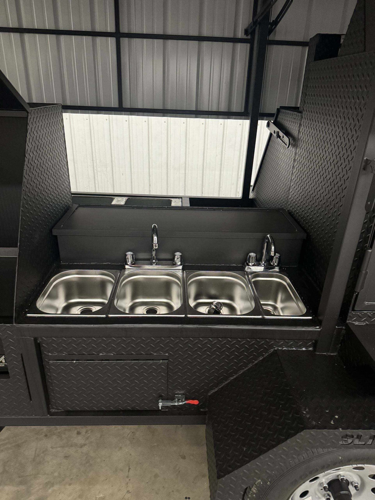 Custom Ultimate Smokehouse commercial smoker with 4-bay sink package, 36-inch griddle, and large charcoal grill in a 72-inch diamond tread steel cabinet