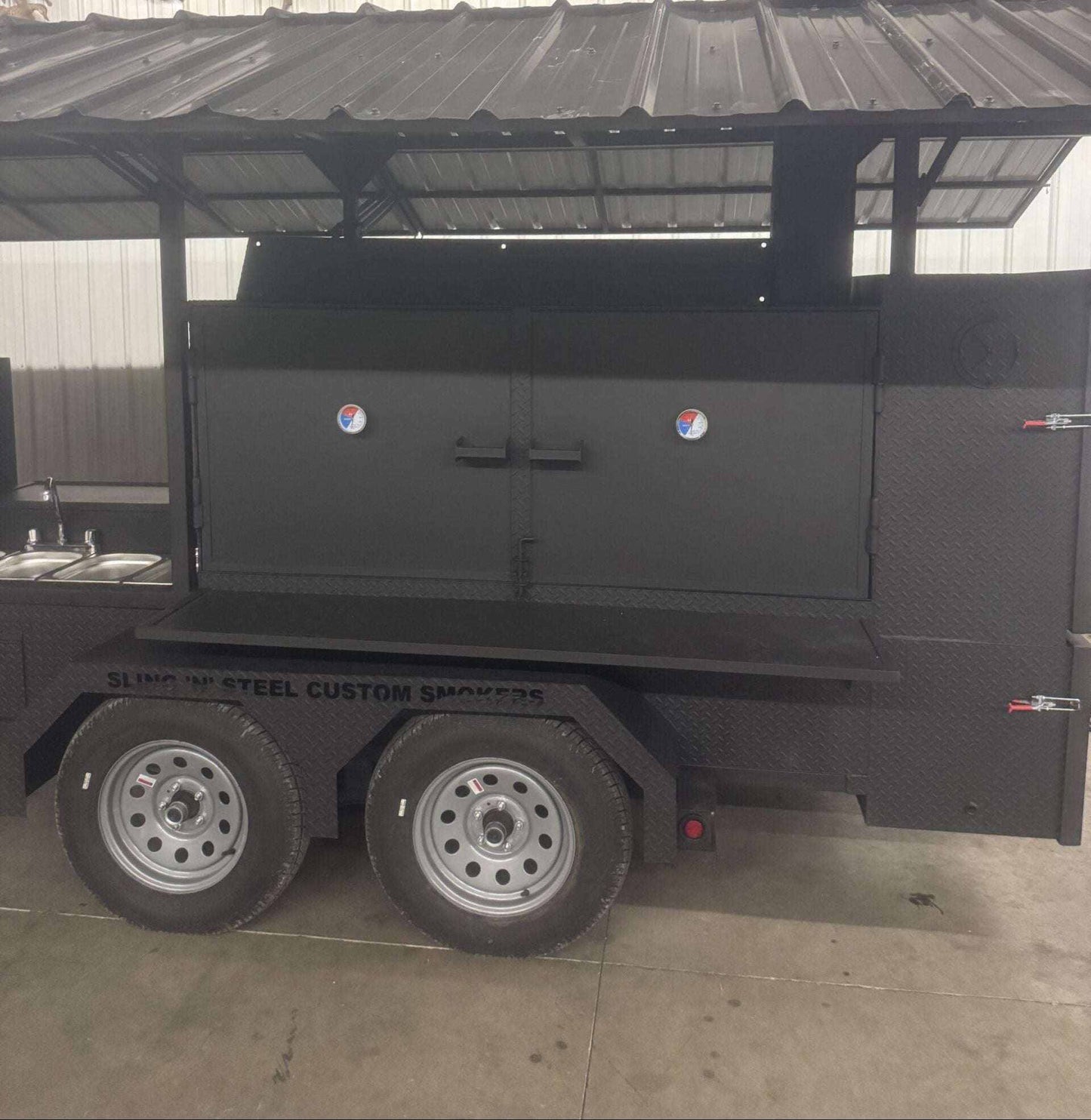 Custom Ultimate Smokehouse 72 smoker trailer with 72-inch charcoal grill, sandwich prep refrigeration, four-bay sink, griddle, and insulated firebox