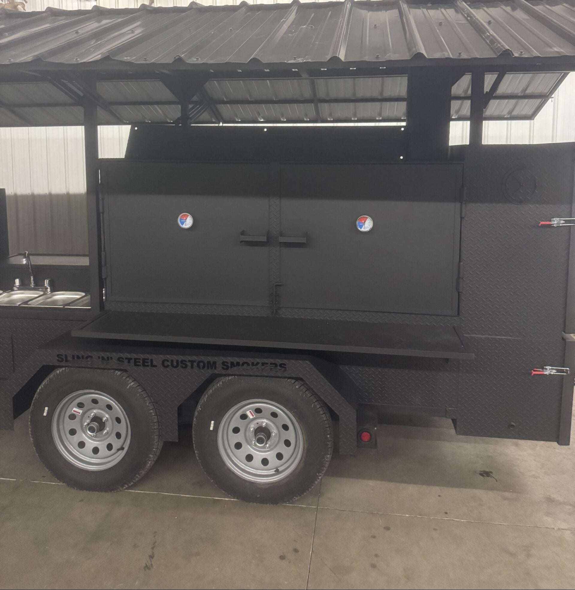 Custom Ultimate Smokehouse 72 smoker trailer with 72-inch charcoal grill, sandwich prep refrigeration, four-bay sink, griddle, and insulated firebox