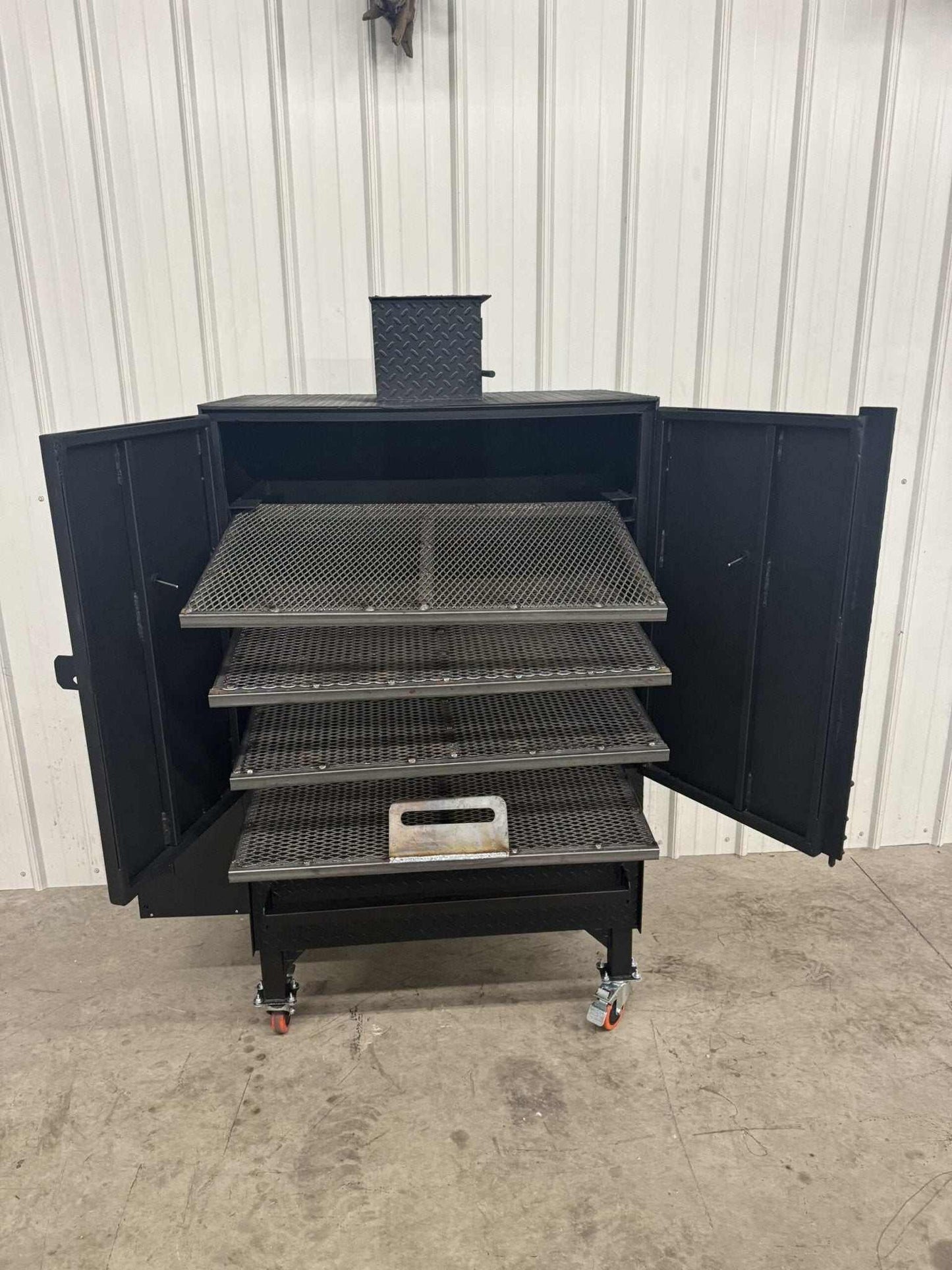 Commercial grade SNS Pellet Vault smoker with four slide-out racks and large hopper, heavy-duty pellet smoker for BBQ and catering use