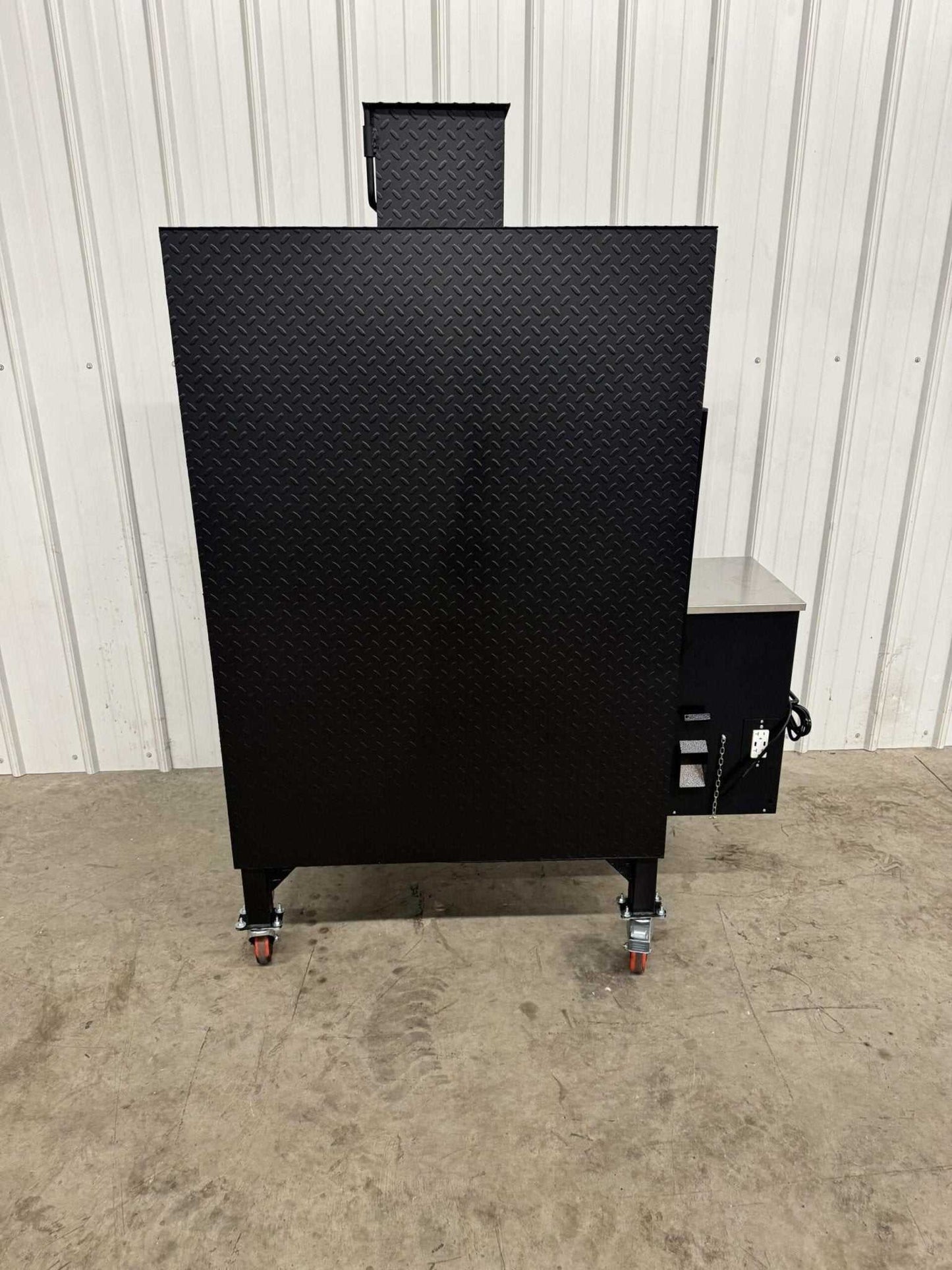 Commercial grade SNS Pellet Vault pellet smoker with heavy-duty black steel construction and caster wheels for easy mobility