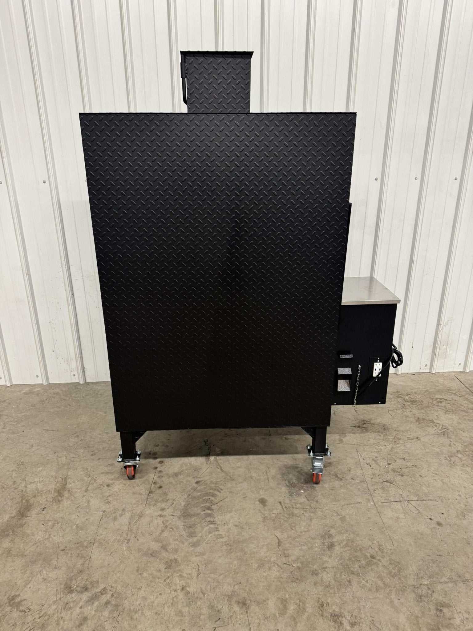 Commercial grade SNS Pellet Vault pellet smoker with heavy-duty black steel construction and caster wheels for easy mobility