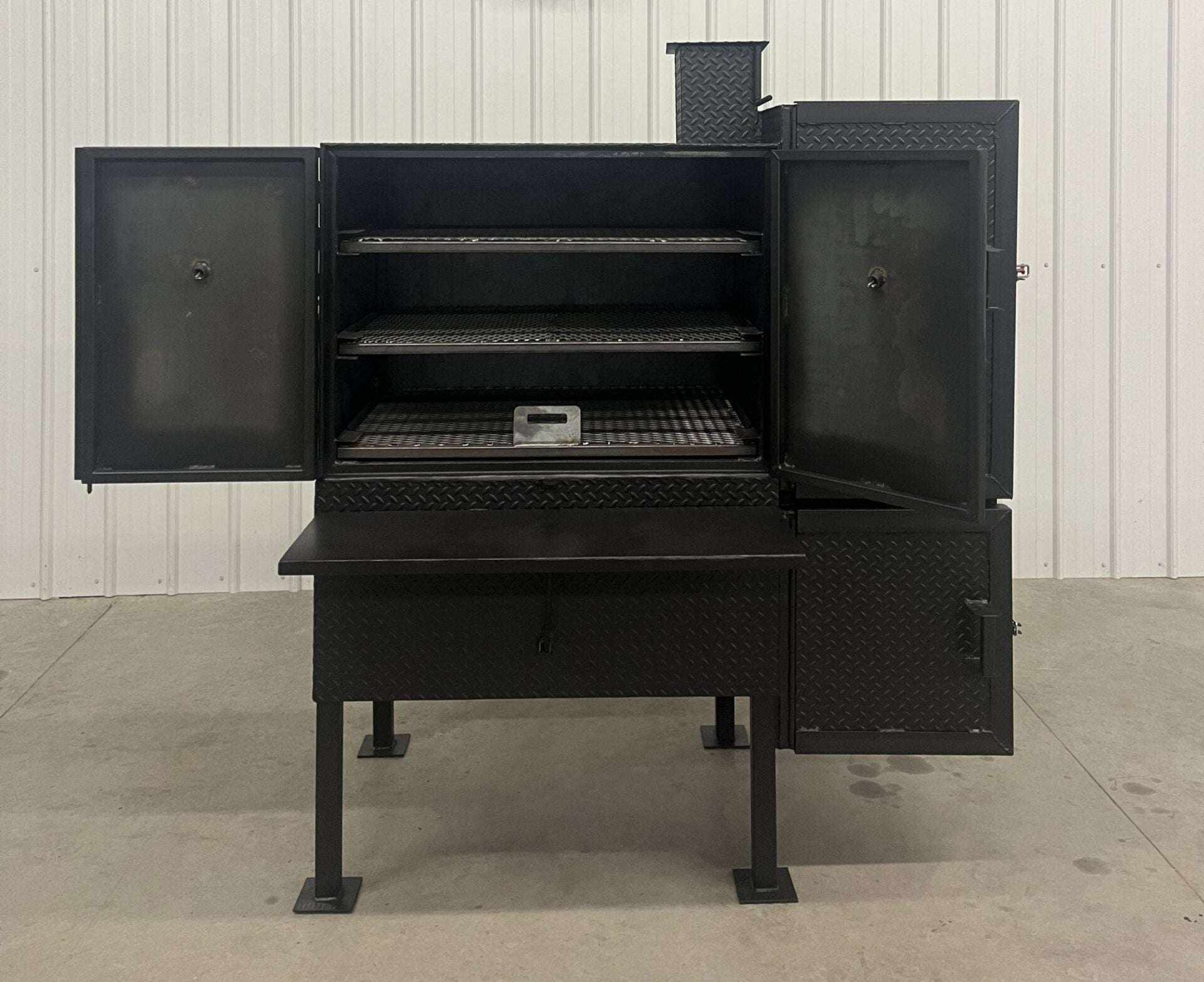 SNS 40 Cabinet Smoker heavy-duty vertical smoker with large 30x40 main chamber and insulated firebox, open doors showing racks inside