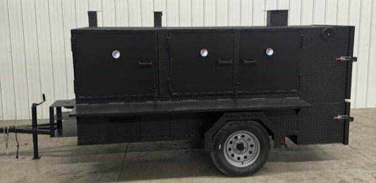 SNS 4060 Cabinet Smoker with charcoal grill on trailer, black steel construction, multiple cooking racks, and insulated firebox for versatile catering use