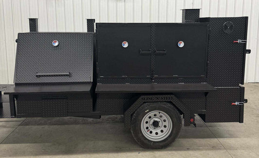 SNS 4060 Smoker grill with cabinet main chamber made of 1/4 inch diamond tread steel, featuring multiple cooking racks, insulated firebox, rib box, charcoal grill, fryer stand, and storage basket on a trailer-mounted unit.