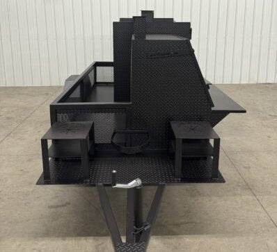 Black SNS 4060 smoker grill with cabinet main chamber and dual fryer stands, designed for high-capacity catering with multiple cooking racks and storage basket.