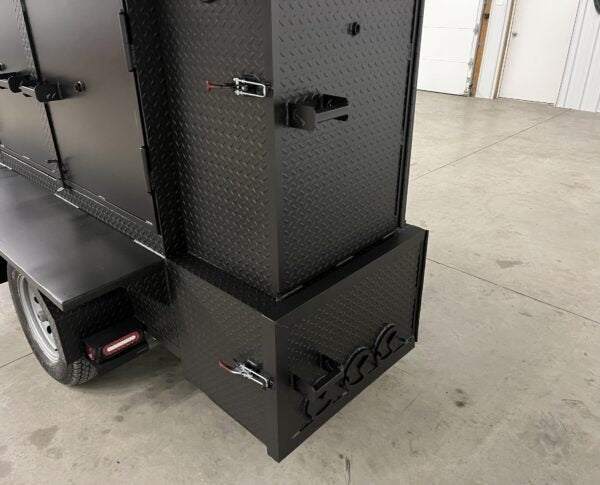 Black SNS 60 smoker cabinet and grill combo with diamond tread steel exterior on trailer base