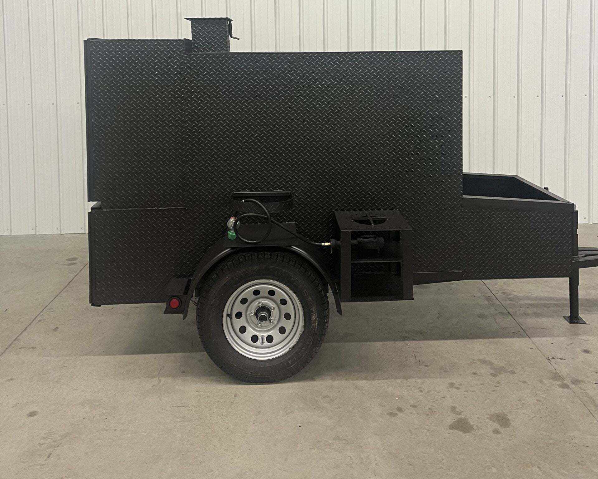 SNS 60 Smoker Cabinet Trailer made of 1/4 inch diamond tread steel with insulated firebox and rib box on single axle trailer