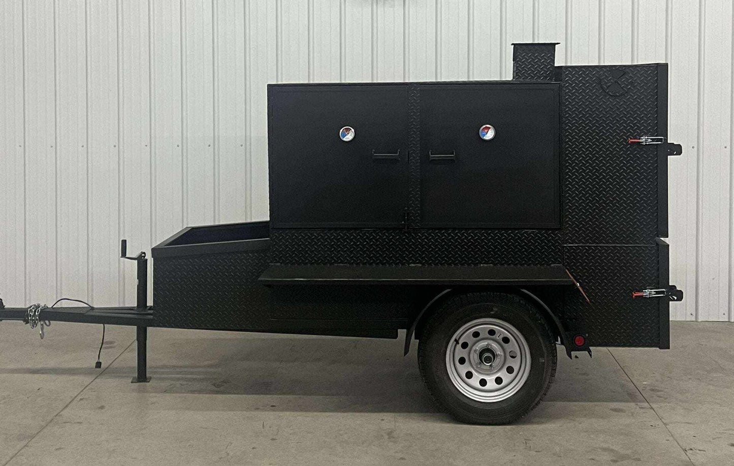 SNS 60 Smoker Cabinet Trailer made of 1/4 inch diamond tread steel with insulated firebox and reverse flow smoker design.