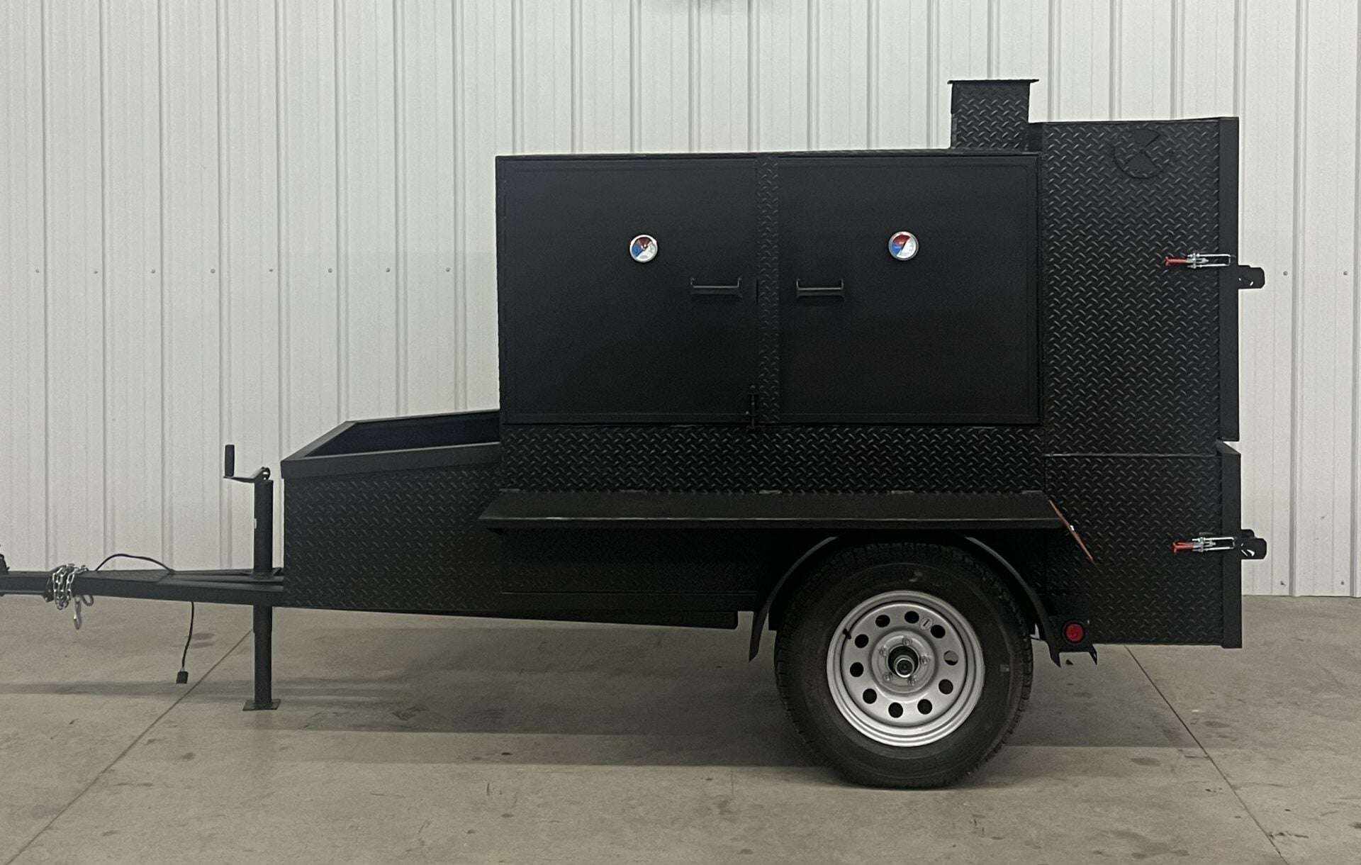SNS 60 Smoker Cabinet Trailer made of 1/4 inch diamond tread steel with insulated firebox and reverse flow smoker design.