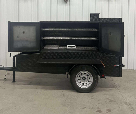 SNS 60 Smoker Cabinet Trailer with open doors, diamond tread steel, three slide-out cooking racks, and insulated firebox.