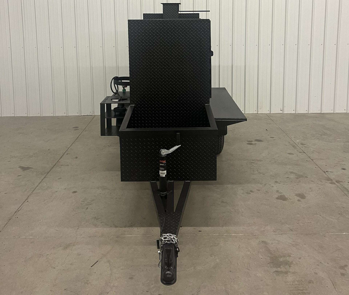 Front view of SNS 60 Cabinet Trailer Smoker made of 1/4 inch diamond tread steel with open main smoker cabinet and firebox with trailer hitch.