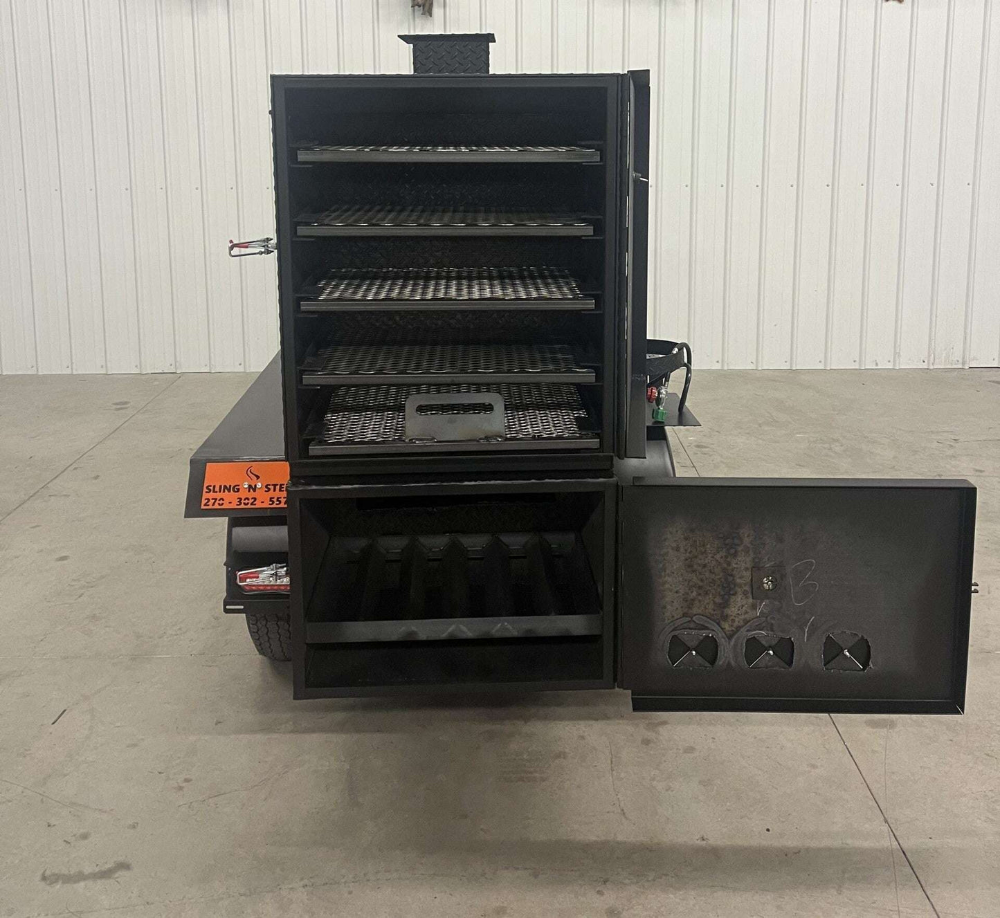 SNS 60 Cabinet Trailer Smoker with open main cabinet and firebox featuring multiple cooking racks and reverse flow design.