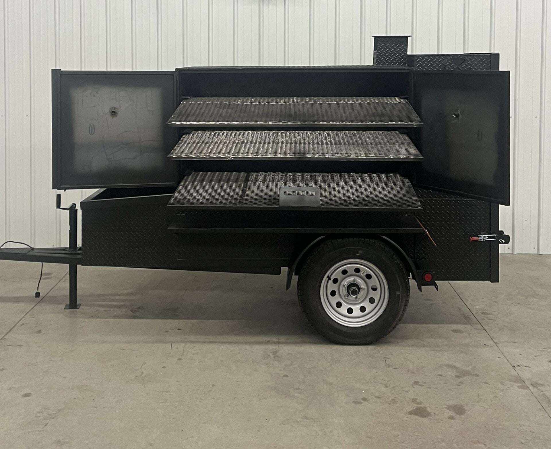 SNS 60 Smoker Cabinet Trailer with open triple cooking racks and diamond tread steel body