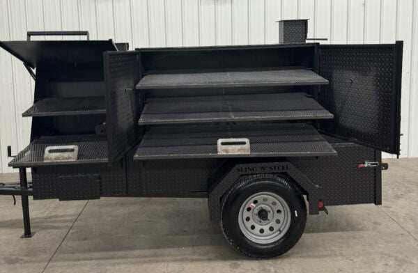 Smoker and Grill SNS 60 Cabinet charcoal grill trailer with multiple grilling racks and storage compartments