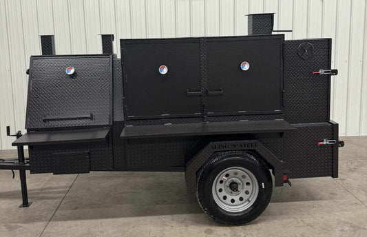 Black Smoker and Grill SNS 60 Cabinet mounted on trailer with multiple doors and temperature gauges in a warehouse setting