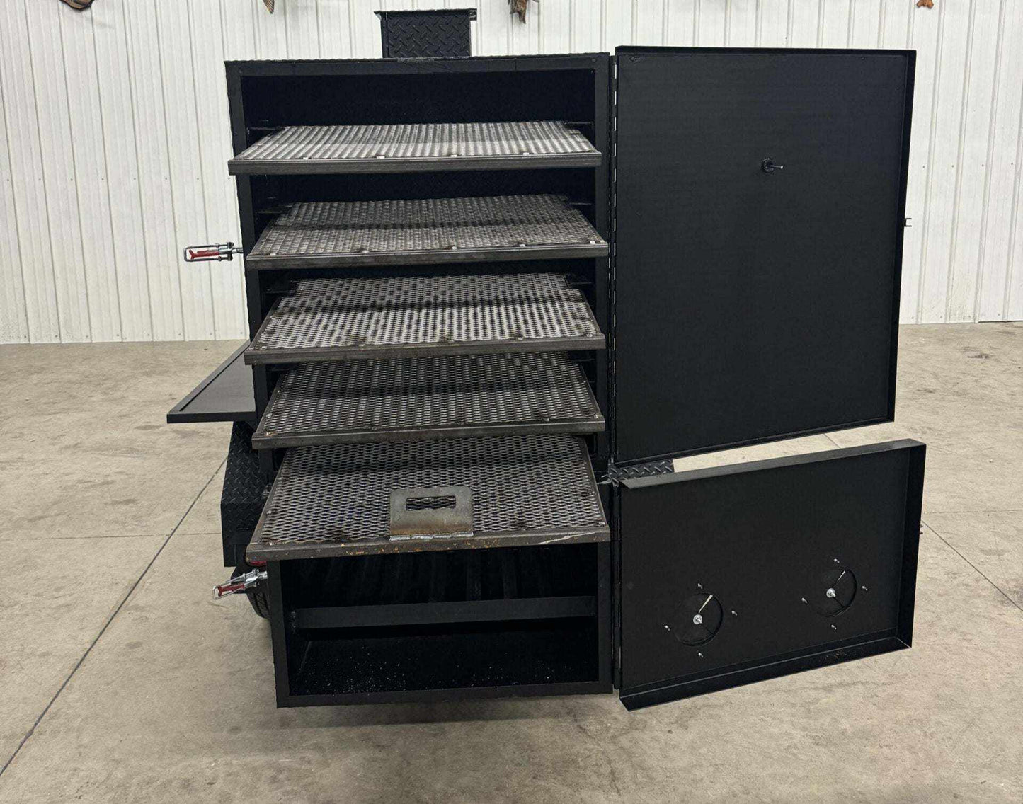 SNS 60 black steel smoker cabinet with multiple cooking racks and open doors on concrete floor