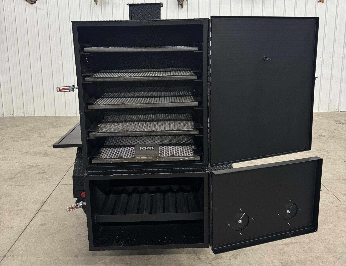 SNS 60 Cabinet reverse flow smoker with multiple cooking racks and insulated firebox in black steel.