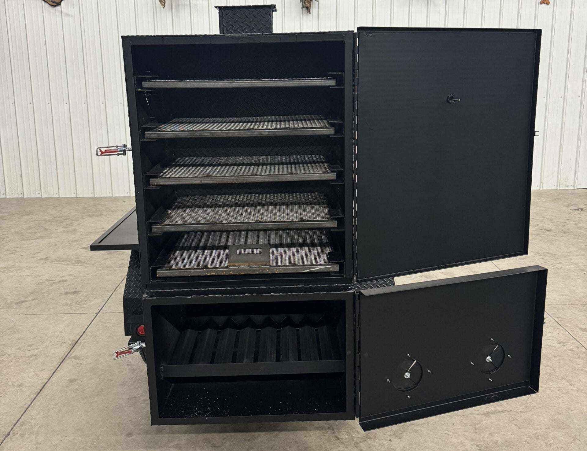 SNS 60 Cabinet smoker with multiple slide-out cooking racks and insulated firebox in black steel design
