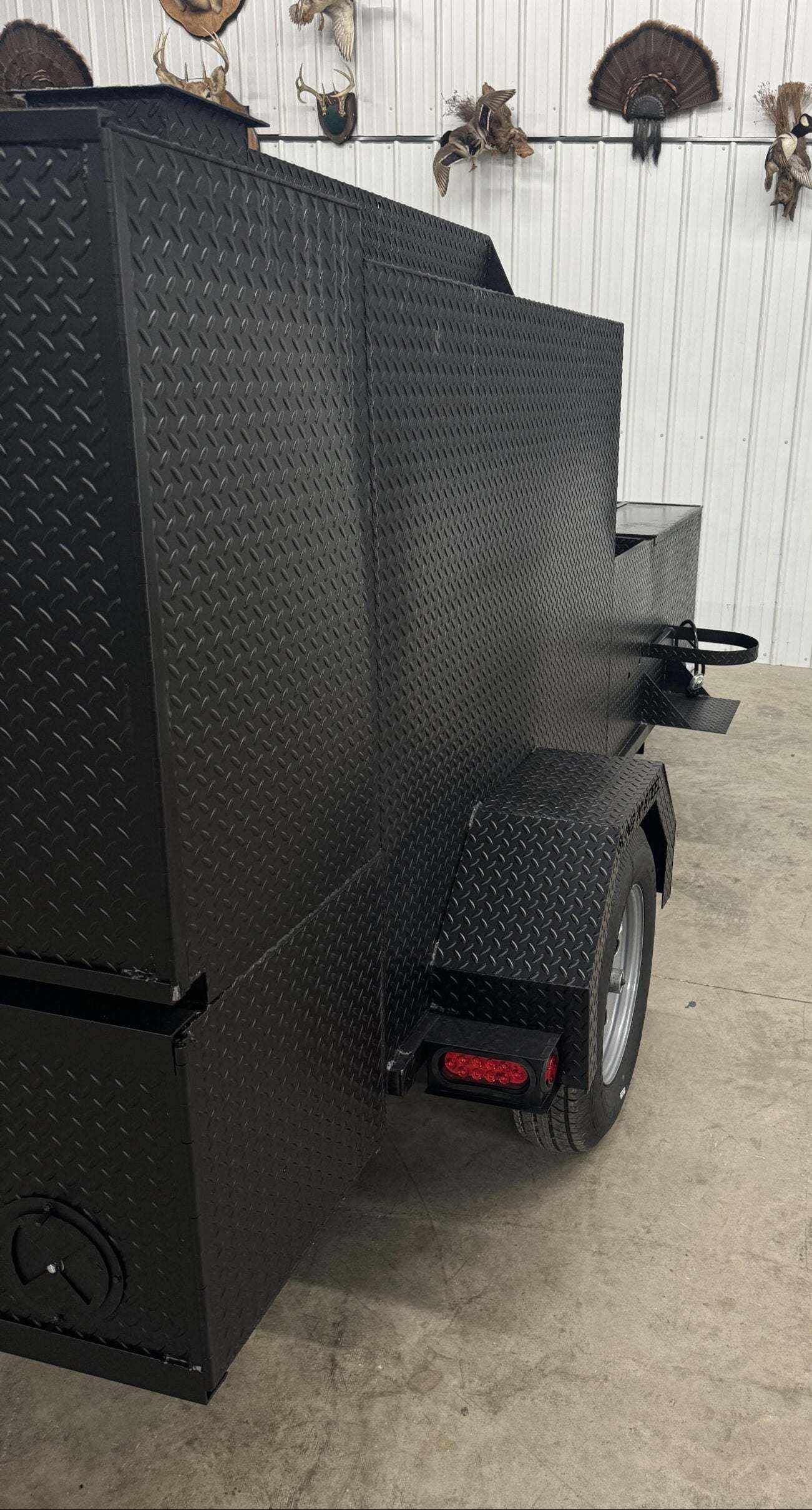 60-inch SNS cabinet smoker with diamond tread steel exterior and trailer wheel for mobility