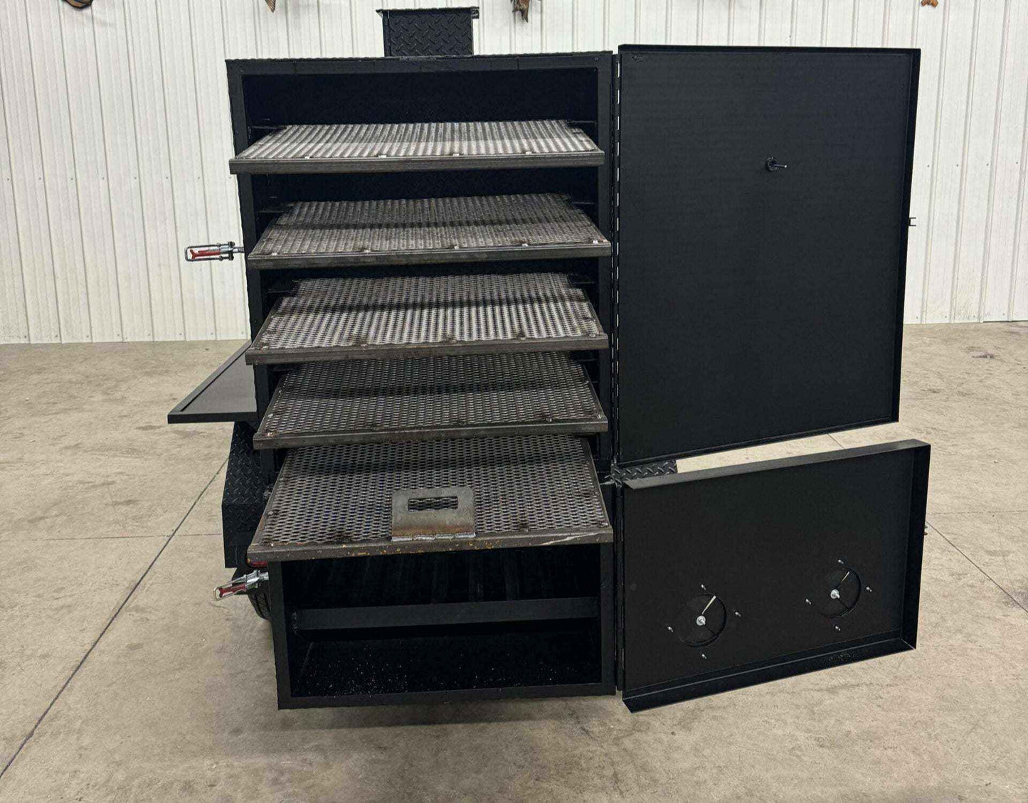 SNS 60 Cabinet large black steel reverse flow smoker with five slide out cooking racks and open doors showing interior compartments