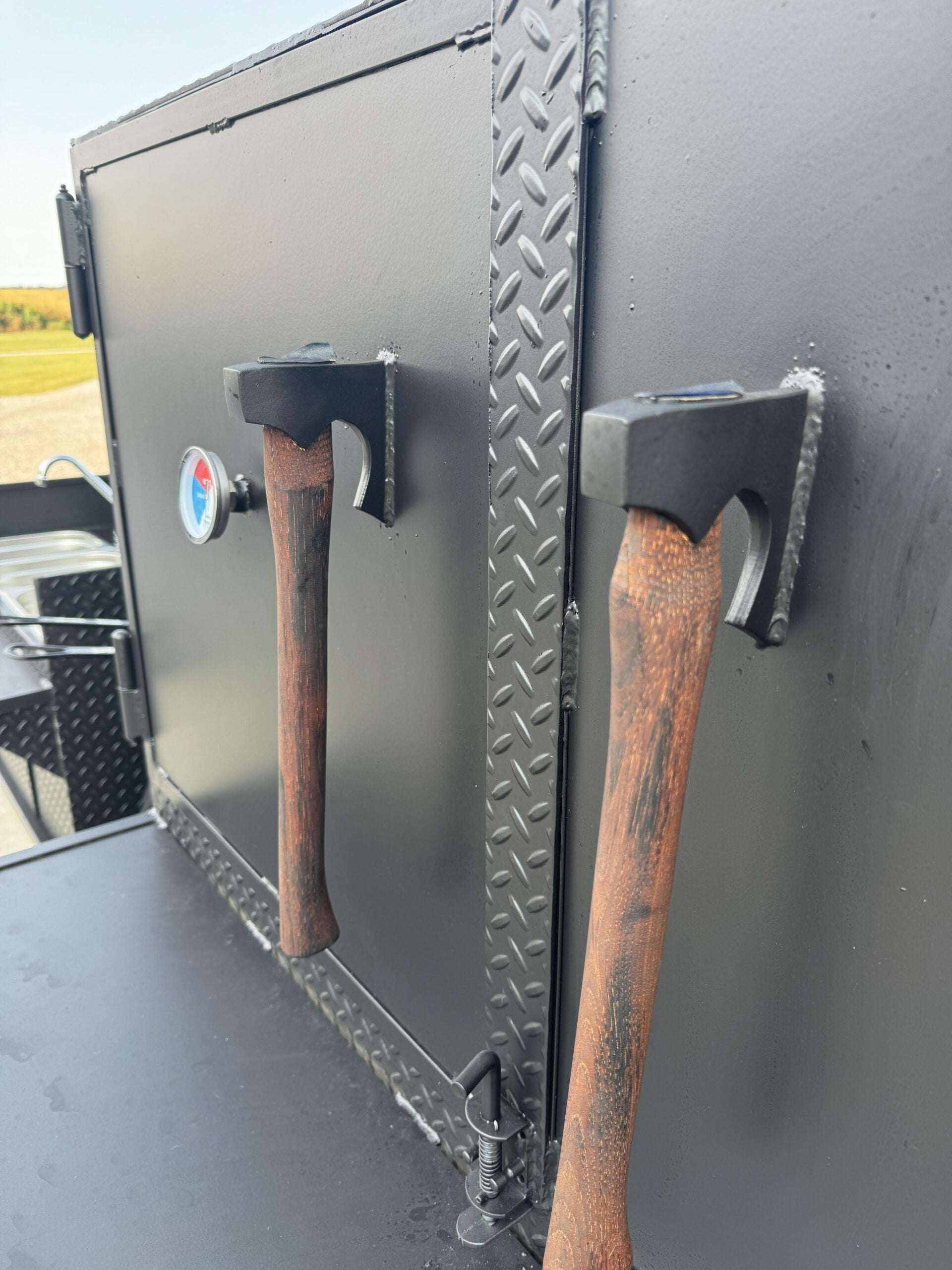 SNS 60 Cabinet close-up showing diamond tread steel door with wooden handles and temperature gauge
