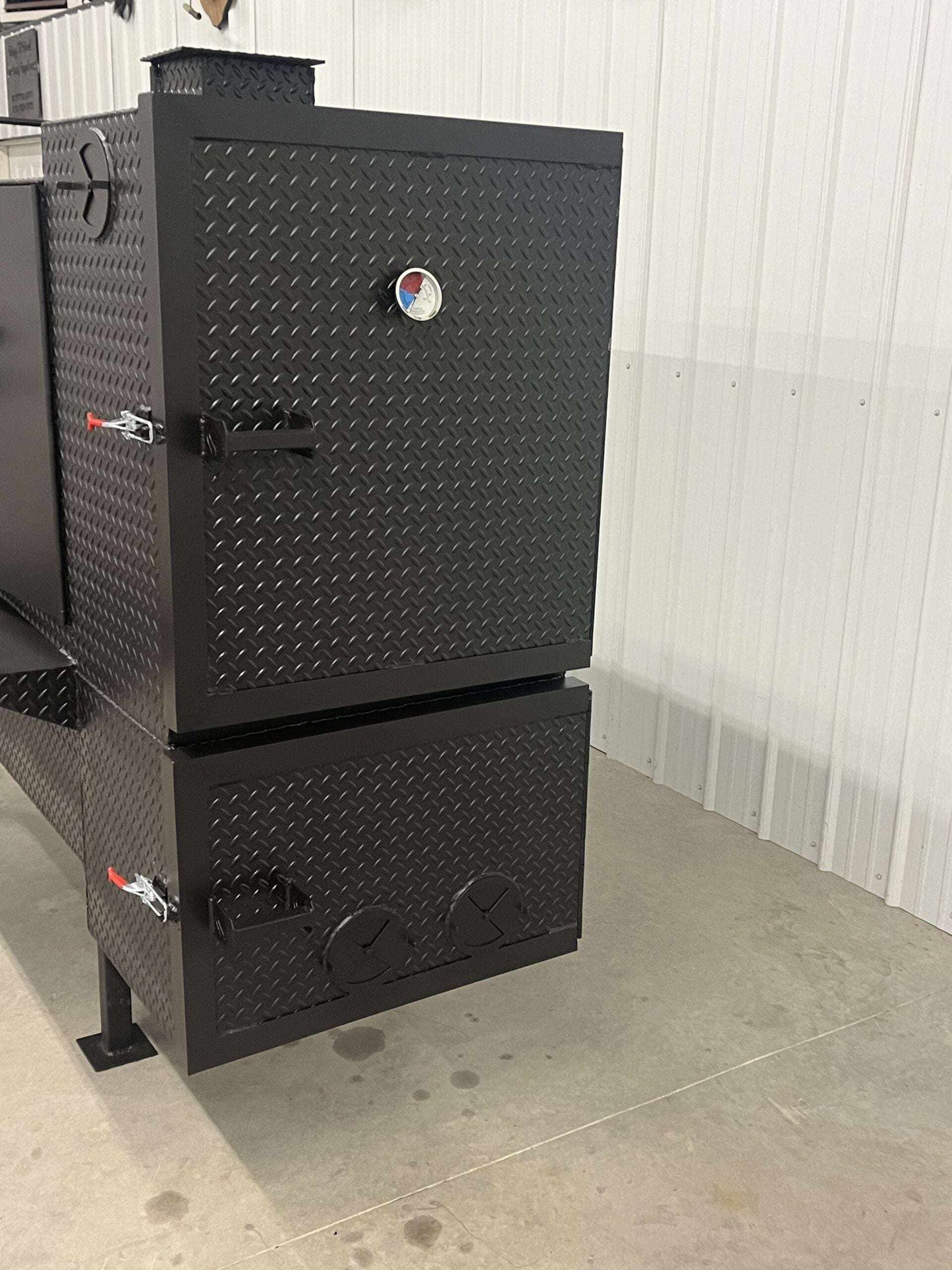 SNS 60 Concession Smoker cabinet in black diamond tread steel with insulated firebox and three slide out cooking racks for commercial smoking