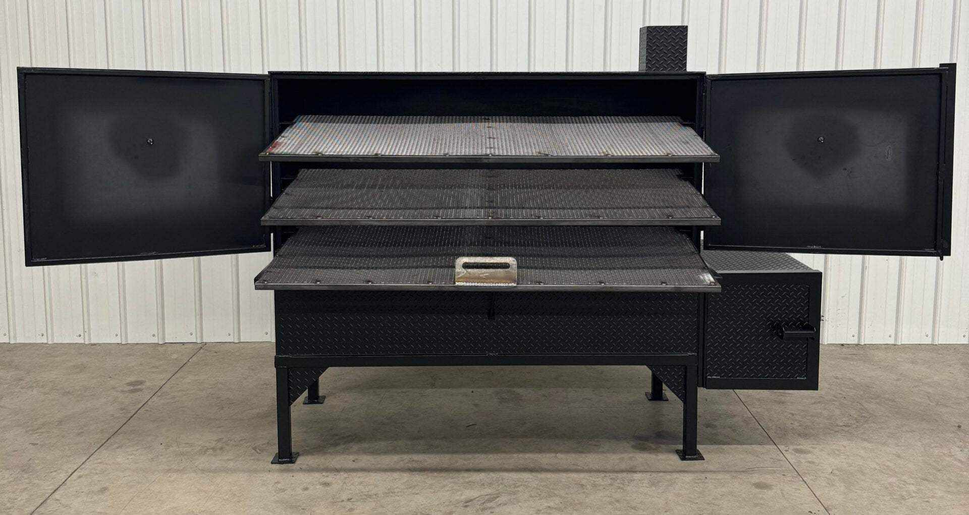 Box Smoker SNS 72-inch smoker cabinet with three slide-out cooking racks and insulated firebox, made of diamond tread steel.