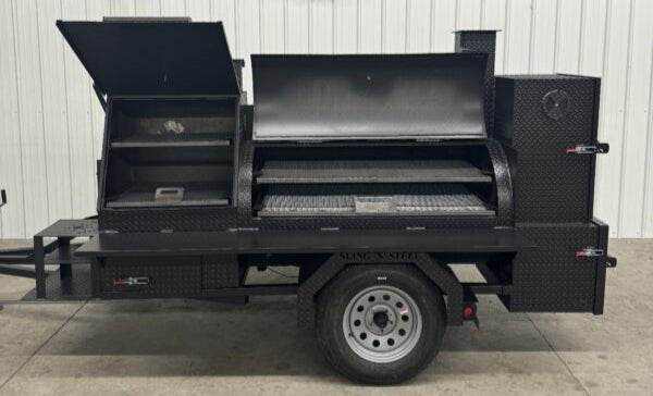 Offset Smoker SNS barrel catering trailer with sink package and multiple cooking racks on trailer chassis